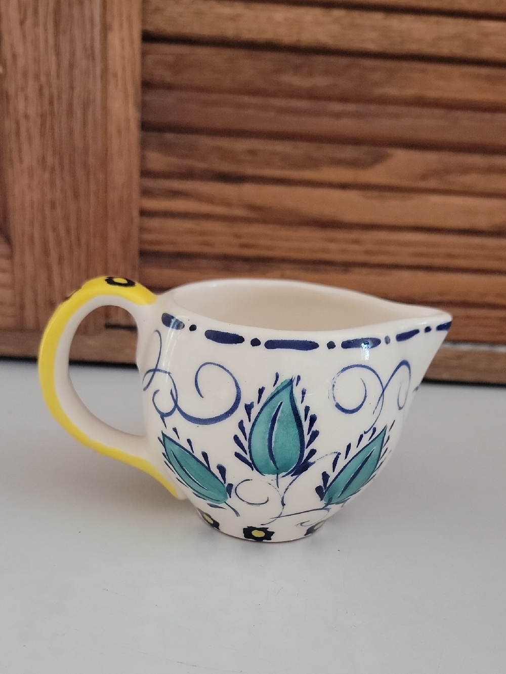 Anthropologie Hand Painted Ceramic Creamer with Teal Leaf Motif Yellow Handle